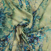 Mridu Digitally Printed Modal Satin Fabric on Pale Mint Green Base with blue floral patterns
